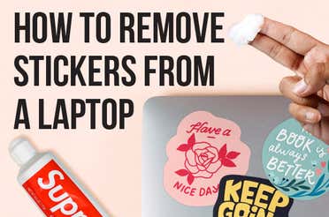 A laptop with three stickers stuck on the cover.